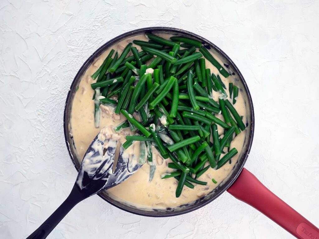 adding beans to the mushrooms sauce