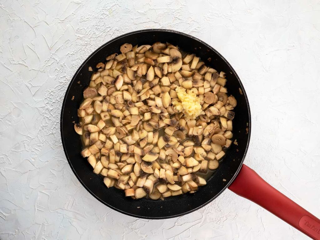 crushed garlic added to the mushrooms