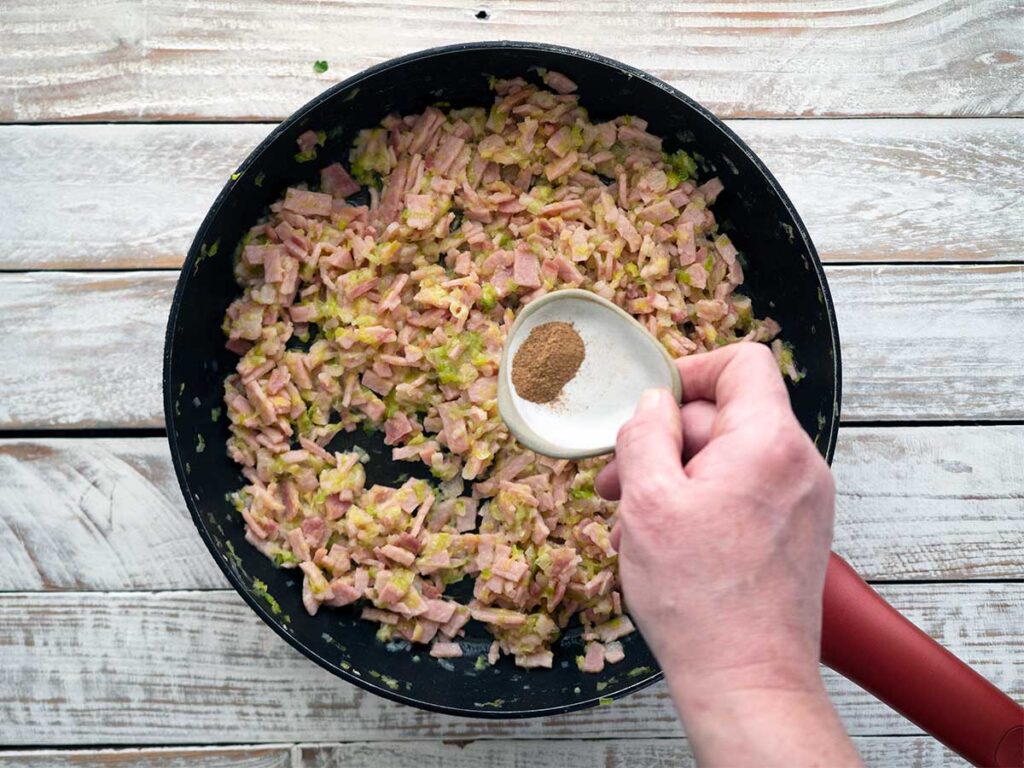 adding nutmeg to bacon mixture