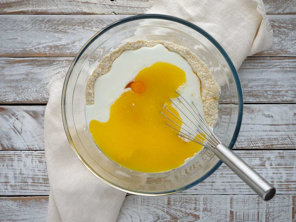 adding wet ingredients to the bowl