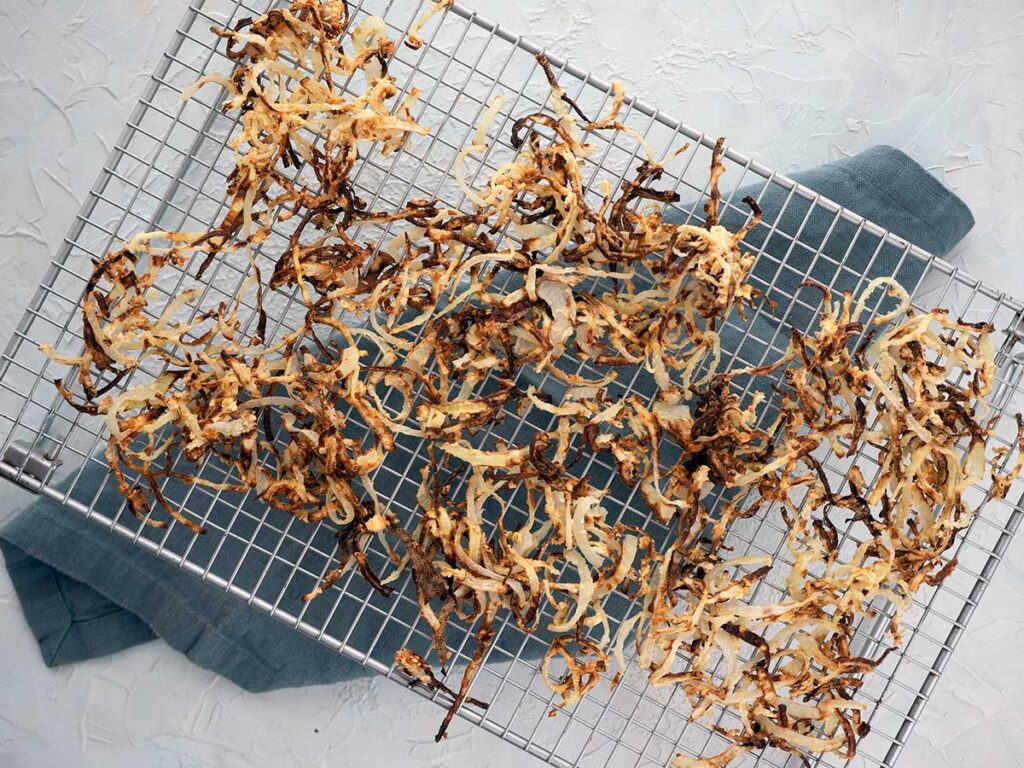 air fryer onions resting on a cooling rack