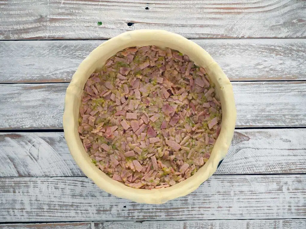 layer of bacon and leek in pie case