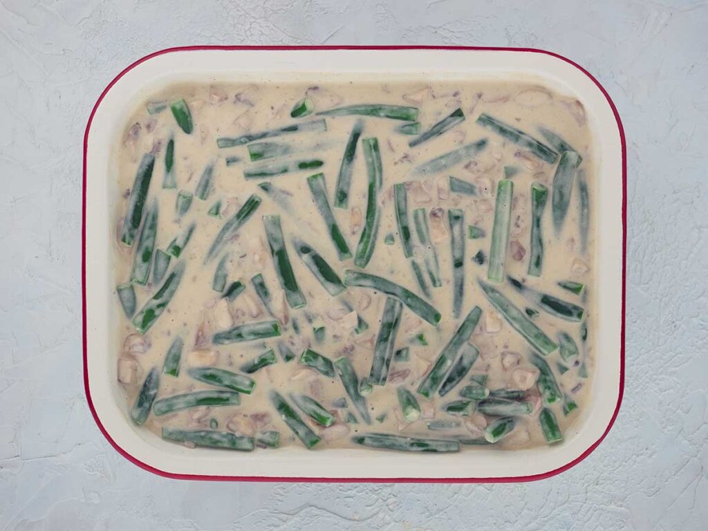 green beans and mushroom sauce mixture in a baking dish