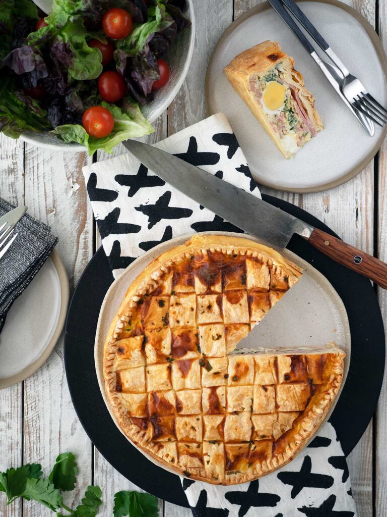 A sliced cut from the bacon and egg pie