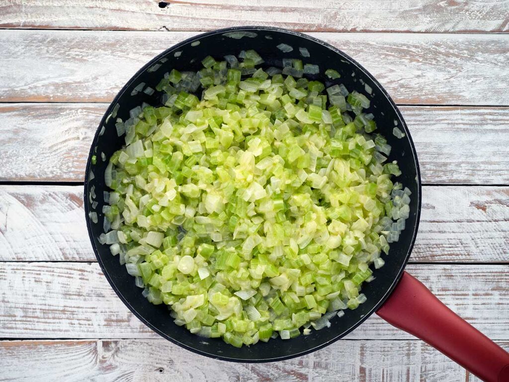 vegetable mix in a pan ready to be added to the cornbread