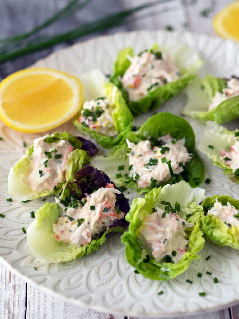 crab lettuce cups and a lemon cheek on a serving platter