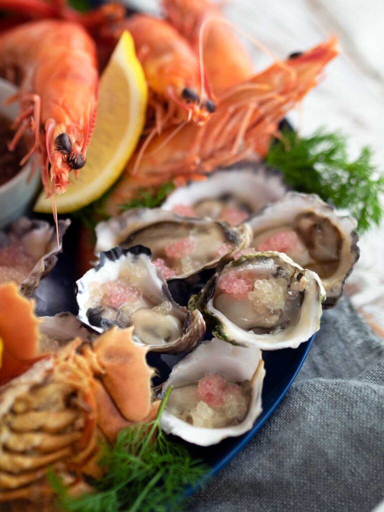 close up of oysters with finger lime, and prawns
