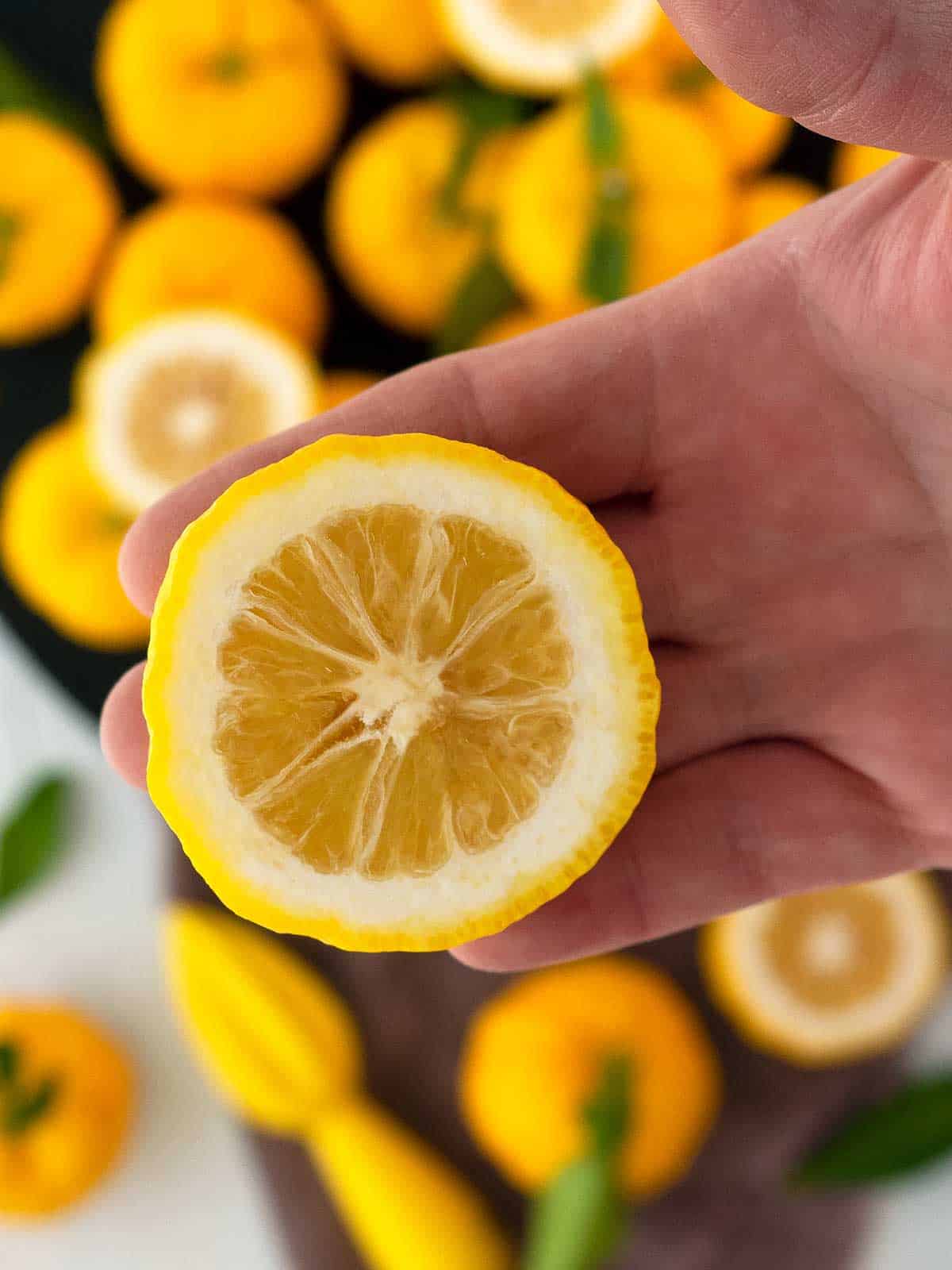 Half a yuzu held in a person's hand.