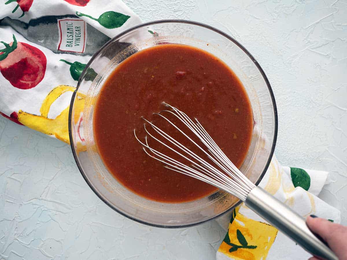Sauce with whisk in a glass bowl.
