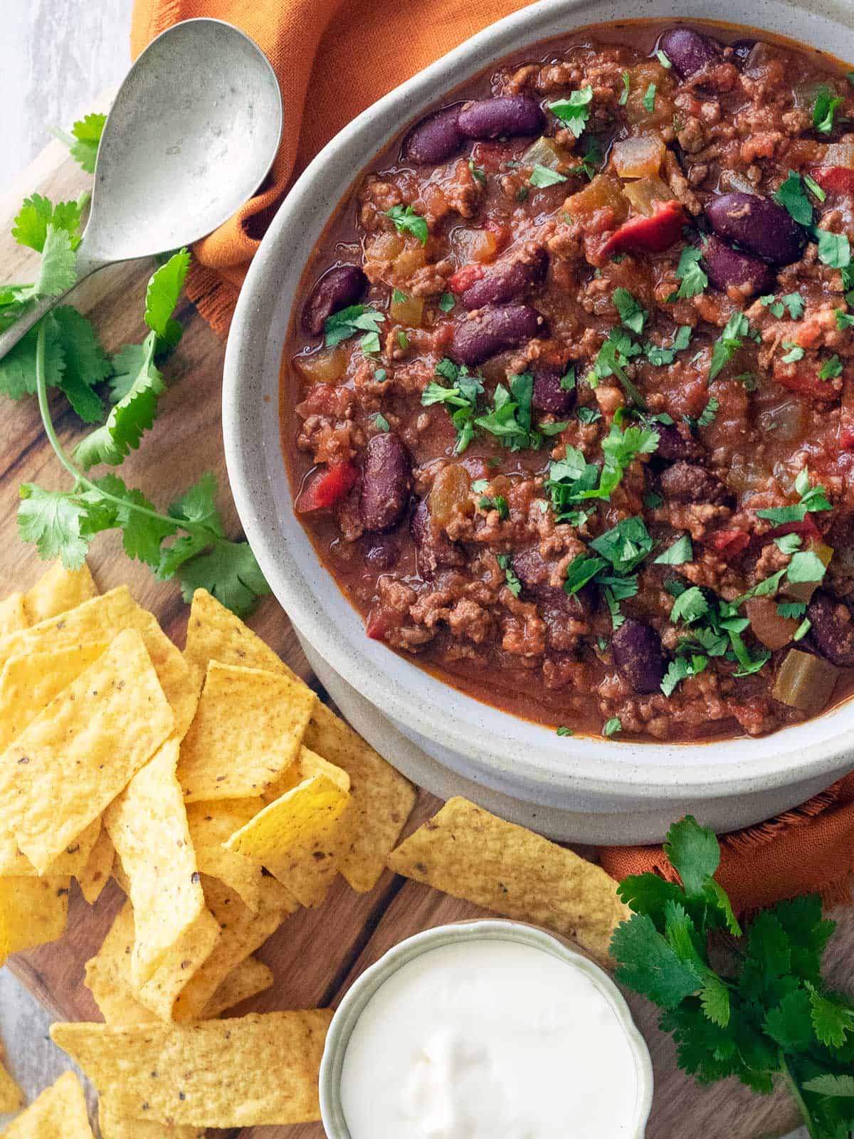 Chilli con carne in a bowl ready for serving with corn chips.