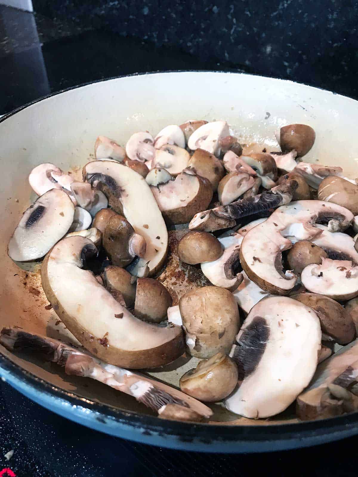 Mushrooms cooking in the pan.