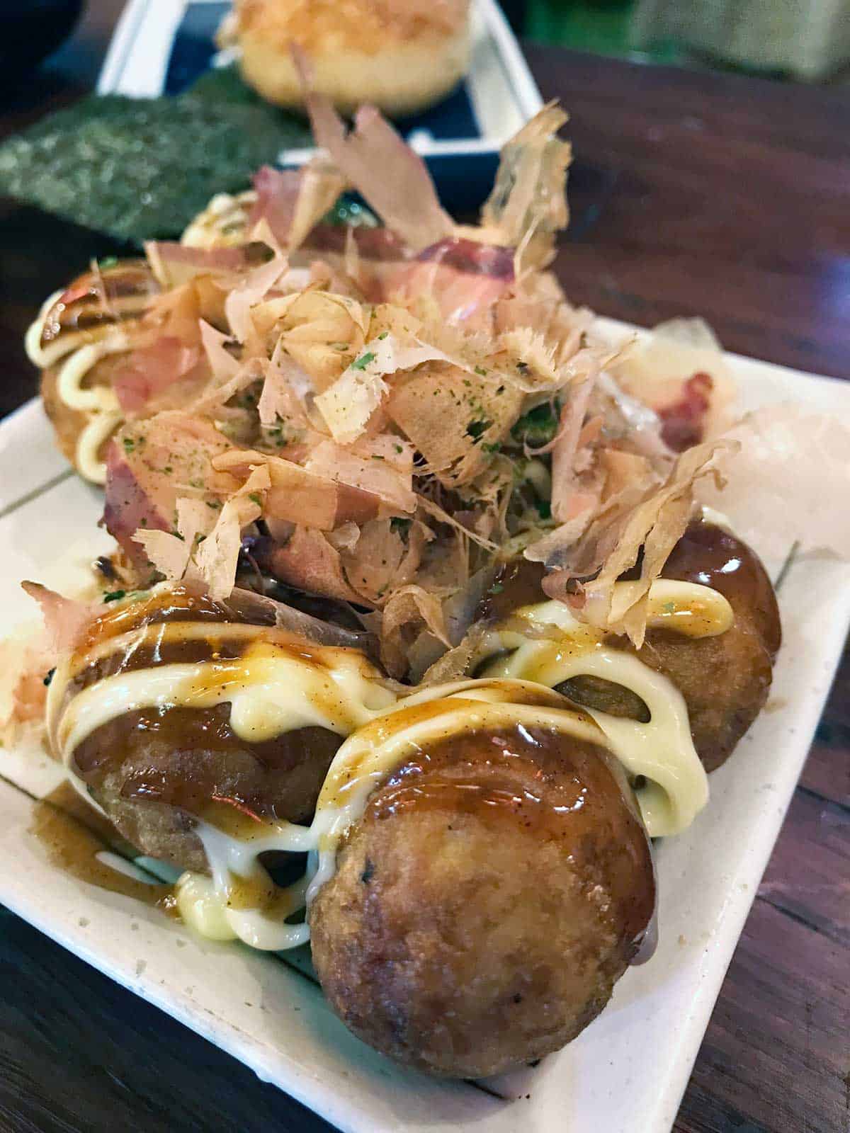 Takoyaki topped with mayonnaise and shaved bonito.