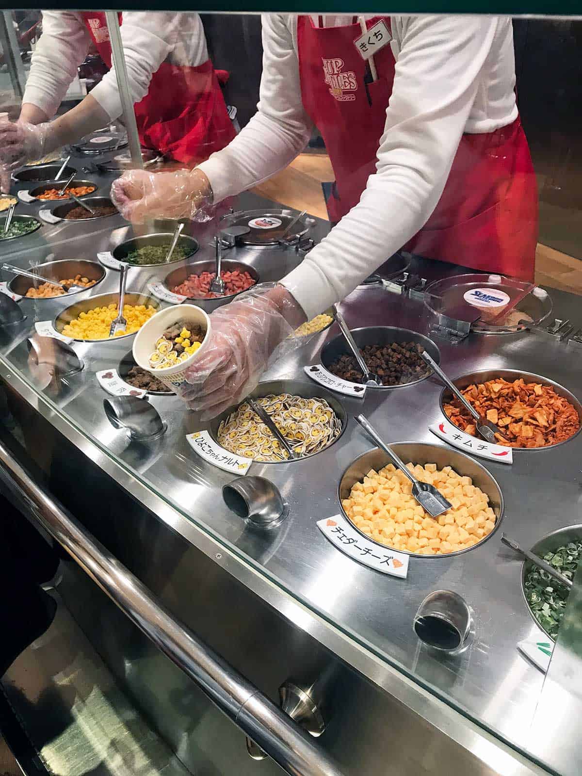 Adding ingredients to the Cup Noodles.