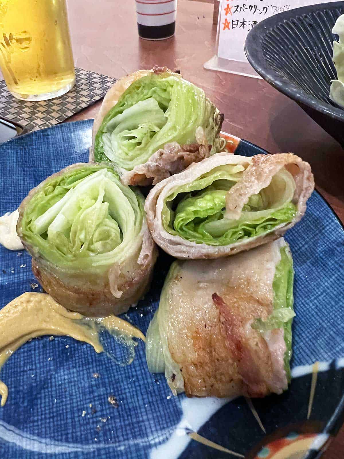 Pork and lettuce kushiyaki on a serving plate.