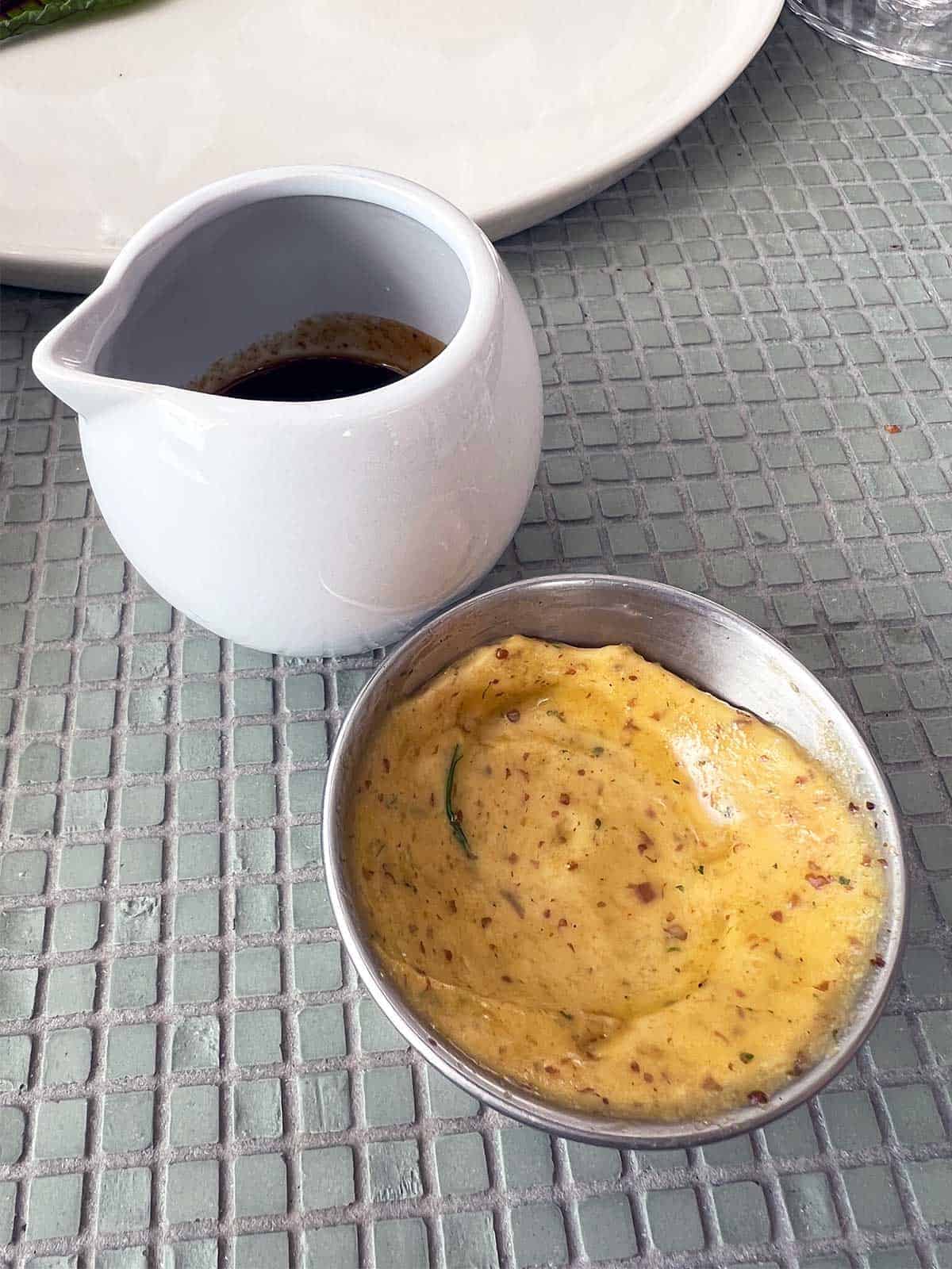 Bowl of mustard and jug of jus.