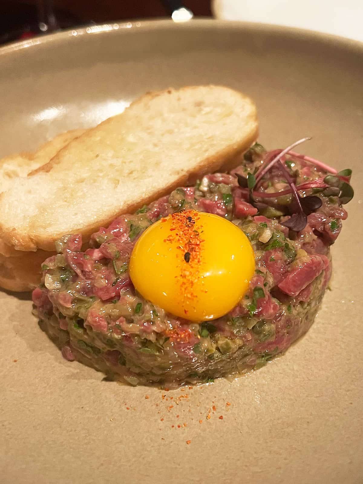 Steak tartare topped with a raw egg yolk.