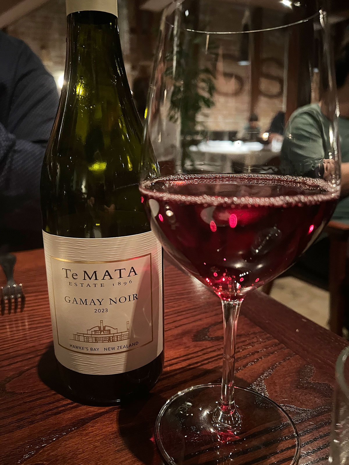Bottle of Te Mata gamy noir and a glass.