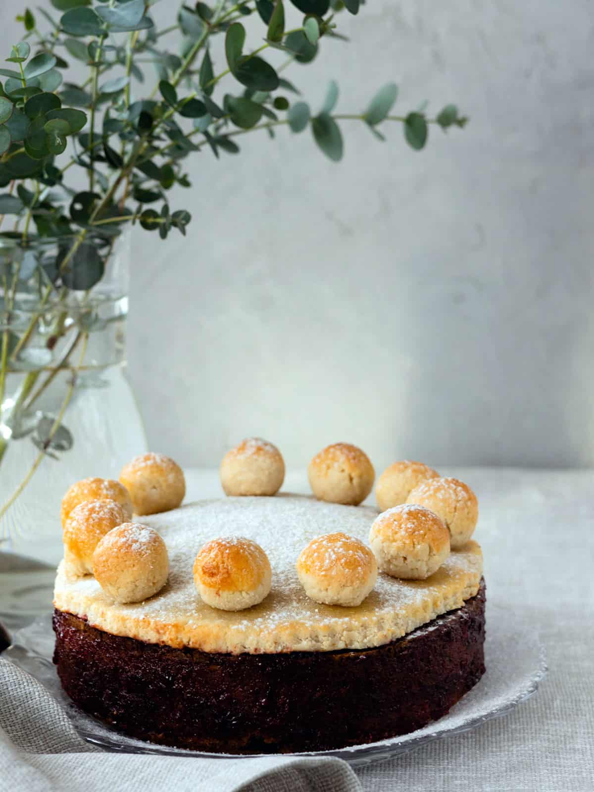 Simnel cake on a plate with a grey back ground.