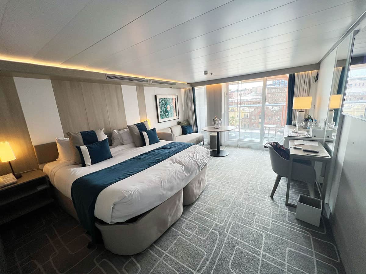 Magic Carpet Suite with a king bed on Celebrity Edge.