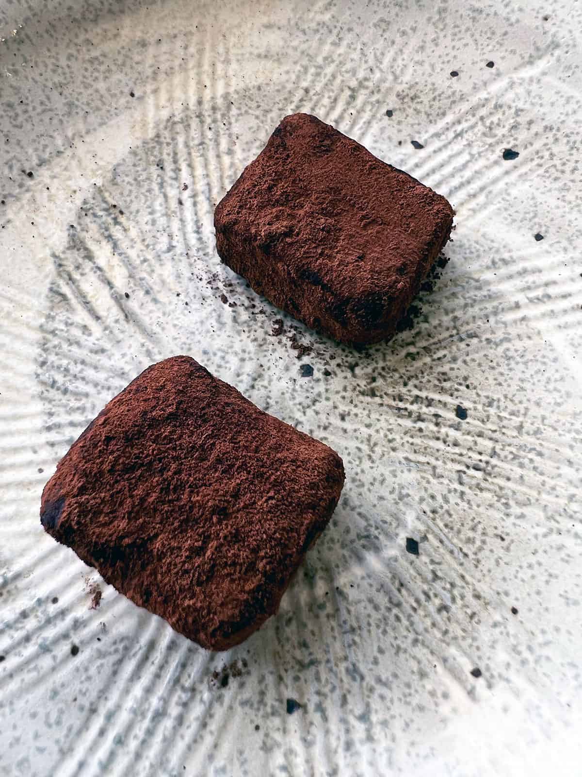 Chocolate truffles on a plate.